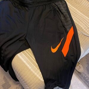 Nike Black Athletic Pants with Orange Swoosh
